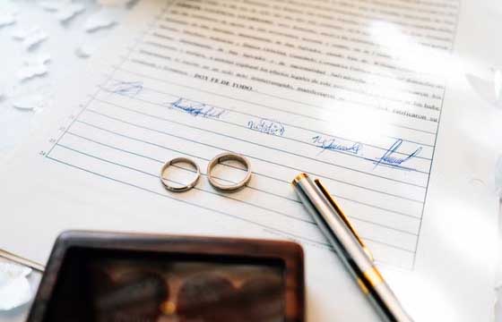 Wedding rings placed on a signed marriage certificate