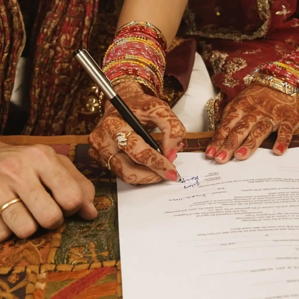 Wedding rings resting on a court marriage registration certificate